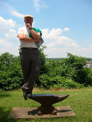 william turnbull standing on the end of an anvil